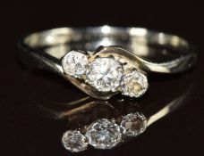 An 18ct gold ring set with three diamonds in a platinum twist setting, 2.2g, size O