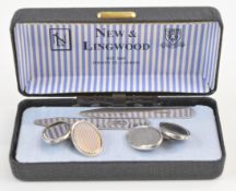 A pair of silver cufflinks and a pair of silver collar stiffeners