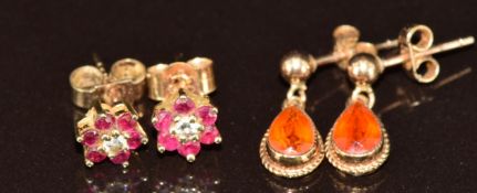 Two pairs of 9ct gold earrings, one set with fire opal and the other a diamond surrounded by rubies,