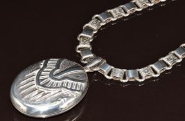 Victorian silver locket with embossed decoration, on original chain made up of smooth and engraved
