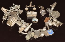 A silver charm bracelet with twenty two silver charms including Champagne, boat, lion, etc , 69g