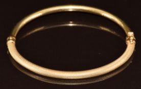 A 9ct gold bangle with textured detail, 4.4g, 5.9 x 5cm