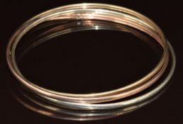 A 9ct gold tri-coloured bangle, 9.3g, 6.8cm