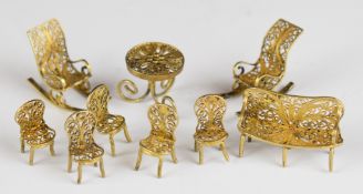 Nine pieces of novelty miniature silver gilt or similar furniture comprising sofa, rocking chair,