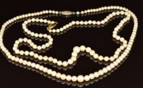 Two cultured pearl necklaces, one with a 9ct white gold clasp set with a diamond and the other