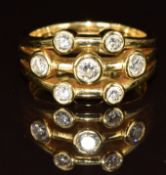 An 18ct gold eternity ring set with seven round cut diamonds, the total diamond weight approximately