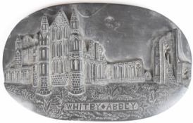 Carved jet oval plaque with relief decoration of Whitby Abbey, W22cm x H14cm