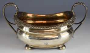 Georgian hallmarked silver twin handled sugar bowl with acanthus leaf scroll handle, raised on