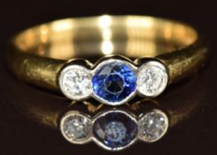 An 18ct gold ring set with a round cut sapphire of approximately 0.2ct and two diamonds, 3.7g,