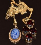 Two 9ct gold pendants, one set with four oval cut garnets and one set with a sodalite cabochon, with