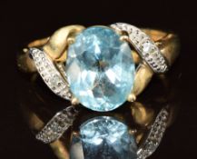 A 9ct gold ring set with an oval cut topaz and diamonds, 3g, size L