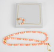 A beaded coral, pearl and 9ct gold necklace (42cm) and one similar earring