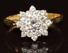 An 18ct gold ring set with a cluster of diamonds, centre diamond approximately 0.15ct, 3.1g, size M