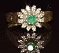 A 9ct gold ring set with a round cut emerald surrounded by diamonds, 3g, size N
