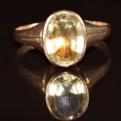 A 9ct rose gold ring set with an oval cut citrine in a foiled setting, 3.7g, size T