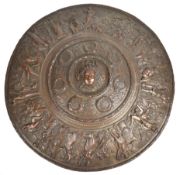 Cast bronze convex parade shield or plaque with repoussé and figural decoration and central Medusa