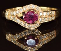 An 18ct gold ring set with an oval cut ruby and diamonds, 3.3g, size R