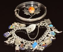 A silver charm bracelet with 20 charms including enamel shields, pixie, Eiffel Tower, etc, silver