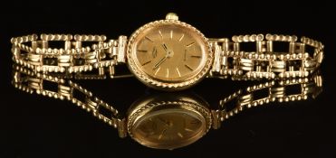 Rotary 9ct gold ladies wristwatch with two-tone hands and baton hour markers, gold dial and quartz