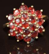 A 9ct gold ring set with a cluster of garnets, 3.4g, size N
