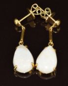 A pair of 14k gold earrings each set with a pear cut opal, 5.9g