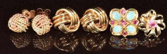 Two pairs of 9ct gold knot earrings (3.3g) and two single earrings one set with a ruby the other