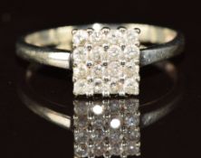 A white metal ring set with sixteen diamonds in a square setting, 1.6g, size N