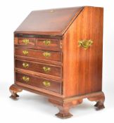 Mahogany apprentice or miniature bureau, the fall flap opening to reveal pigeon holes, central