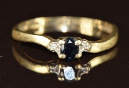 A 9ct gold ring set with a sapphire and diamonds, 1.1g, size L