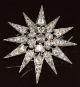 A c1900 18ct white gold metamorphic brooch / pendant set with old cut diamonds, the centre diamond