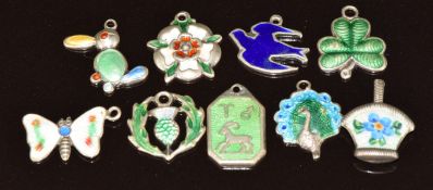 Nine silver charms set with enamel including shamrock, butterfly, peacock, thistle, basket, etc, 9.