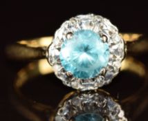 An 18ct gold ring set with a round cut zircon surrounded by diamonds, 3.5g, size K