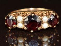 A 9ct gold ring set with garnets and pearls, 3.1g, size M