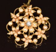 Edwardian 15ct gold pendant / brooch set with an old cut diamond and split pearls in a floral
