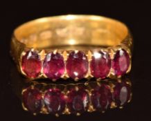 A 22ct gold ring set with five oval garnets, Birmingham 1881, 5.5g, size P