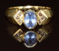 A 14k gold ring set with an oval cut tanzanite and diamonds, 4.3g, size P
