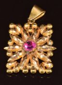 A yellow metal pendant from Bahrain, with faceted decoration and set with paste, 5.4g, 3.2cm