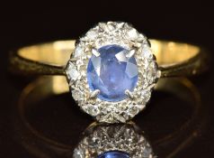 An 18ct gold ring set with a sapphire of approximately 0.4ct surrounded by diamonds, 2.7g, size N