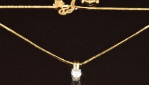 An 18ct gold pendant set with a diamond of approximately (0.5g) on 9ct gold chain (1.2g)