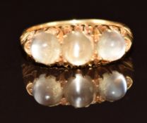 An 18ct gold ring set with three moonstone cabochons, Birmingham 1909, 5.3g, size N
