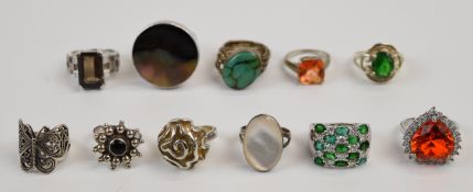 Eleven silver rings including turquoise, mother of pearl, smoky quartz, etc, 82g