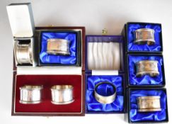 Eight cased hallmarked silver napkin rings, mostly modern with feature hallmarks, weight of all