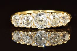 A late Victorian 18ct gold ring set with five old cut diamonds measuring approximately 0.7, 0.35,