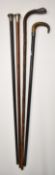 Four walking sticks including three hallmarked silver mounted, one with horn handle, L90cm