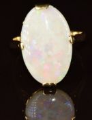 A 18k gold ring set with an oval opal cabcohon, 4.2g, size O