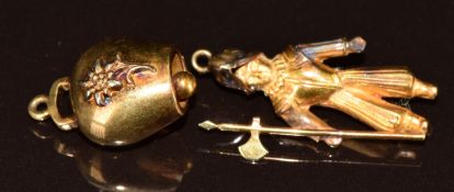An 18ct gold charm in the form of a knight and an 18ct gold bell charm, 4.7g