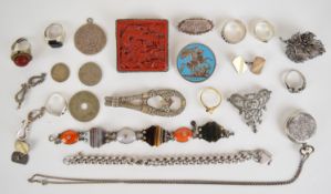 A collection of silver jewellery, rings including buckle and a Chinese example set with cinnabar