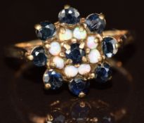 A 9ct gold ring set with opals and sapphires in a cluster, 2.6g, size O