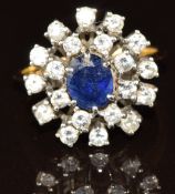 An 18ct gold ring set with an oval cut sapphire of approximately 0.8ct surrounded by diamonds, 5g,