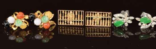 A pair of white metal earrings set with jadeite and diamonds, a pair of yellow metal earrings set